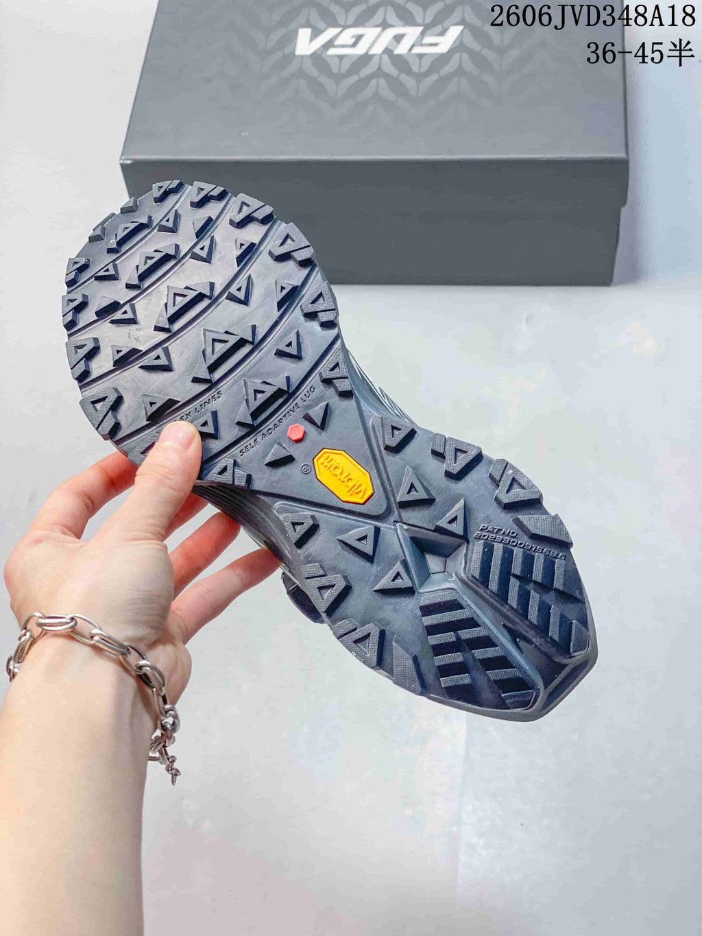 Close-up of the trail shoe outsole showing deep lugs and VIBRAM branding