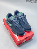 Pair of navy Nike Big Low low-top sneakers with mint accents, shown on a red shoe box