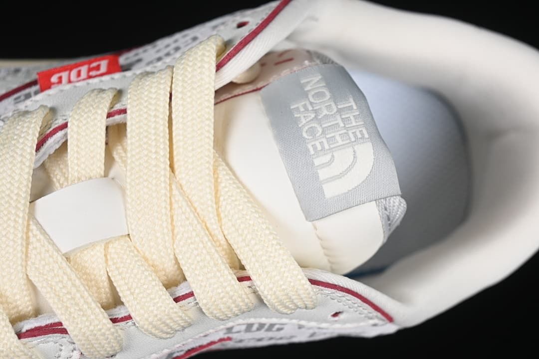 Close-up of cream laces and tongue label.