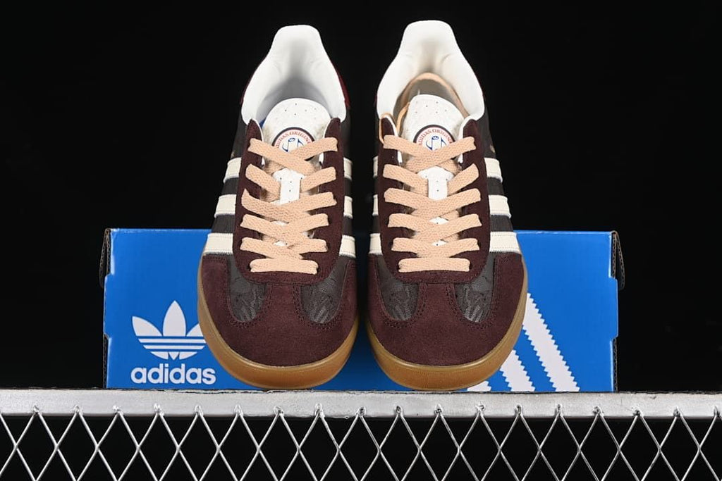 Front view of the pair displayed on a blue adidas box.