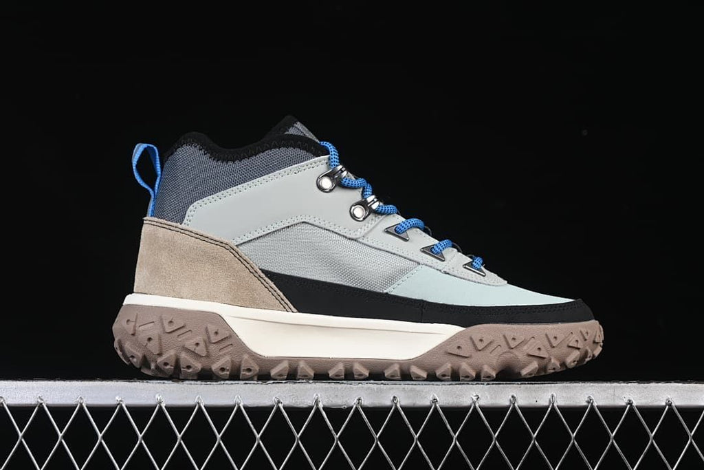 Side profile of the boot with a tan heel panel and textured outsole