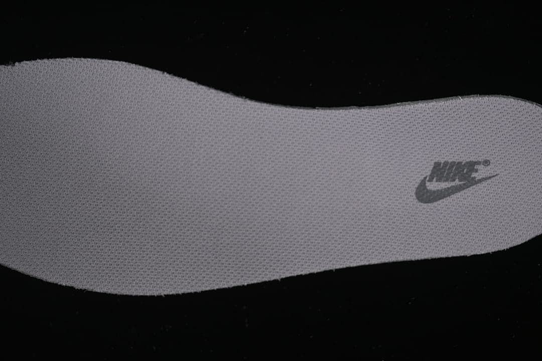 Close-up view of a textured shoe insert with Nike branding