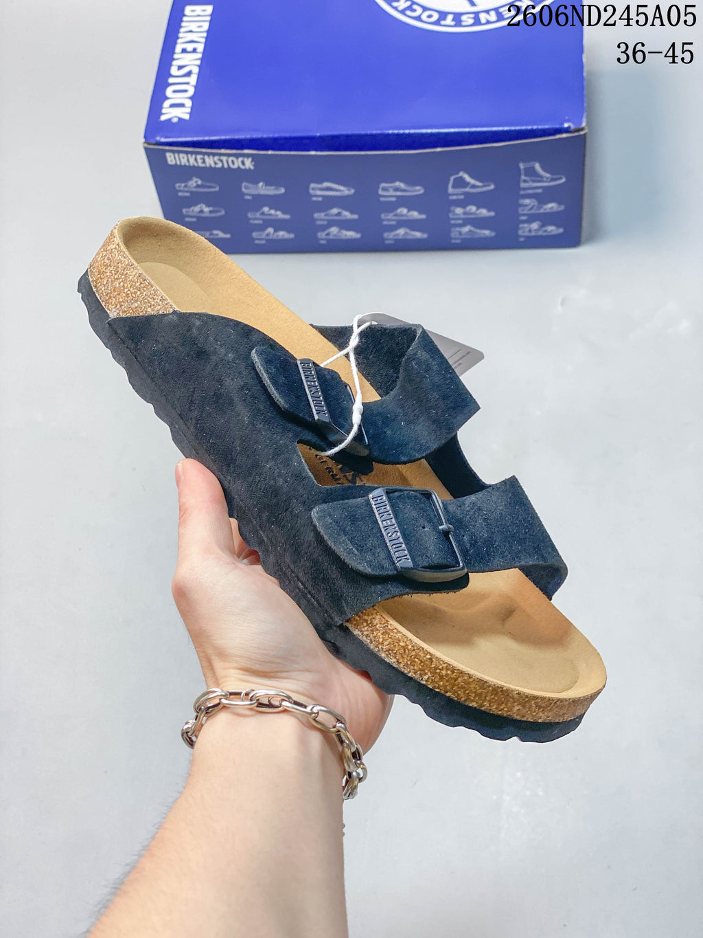 Navy two-strap sandal with dark buckle hardware.