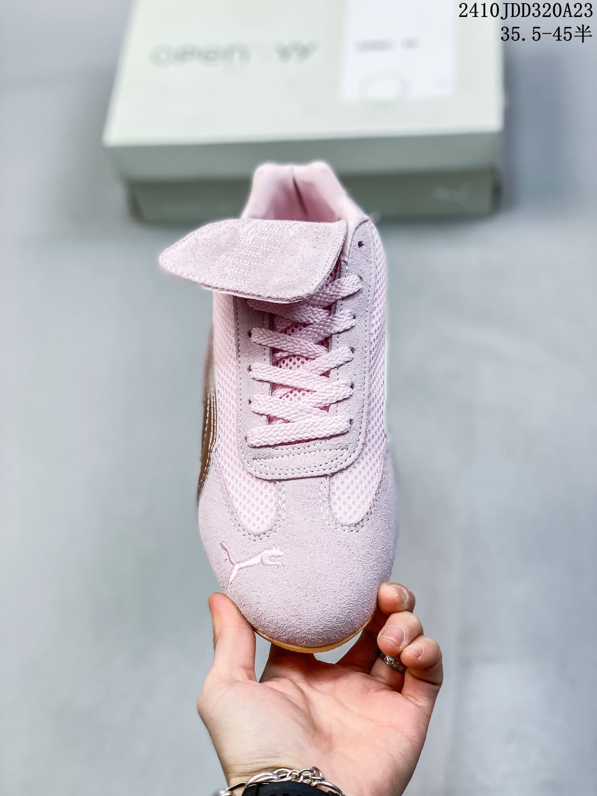 Front view of the pink sneaker showing its laces and removable tongue flap