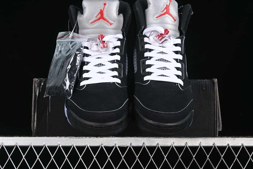 Front view of the pair with silver tongues, red Jumpman details, and white laces