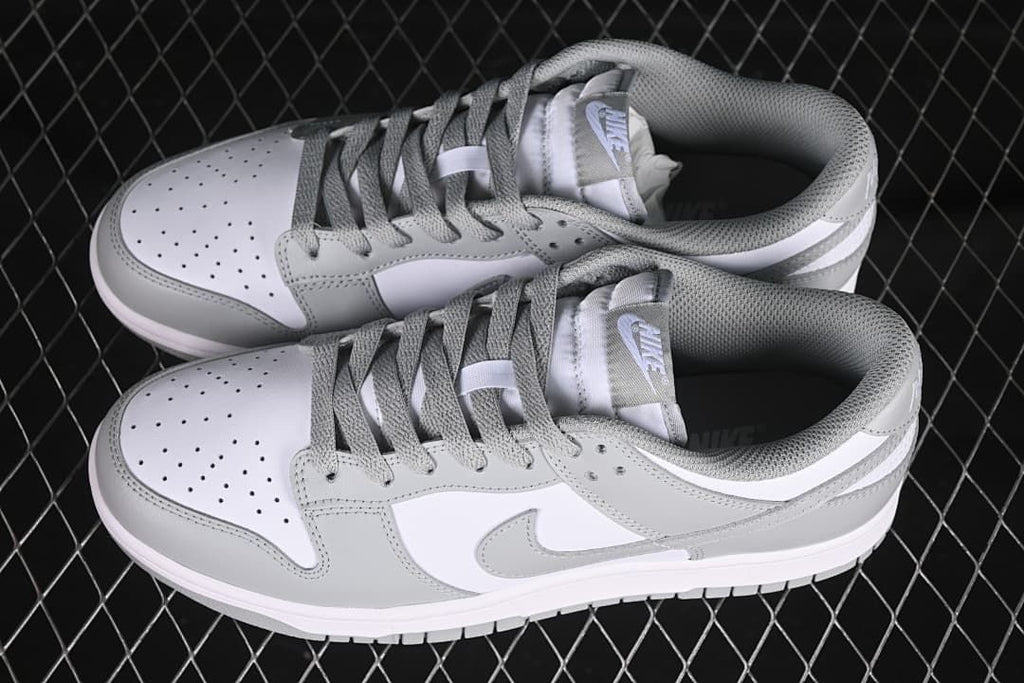 Pair of white and grey low-top sneakers viewed from above
