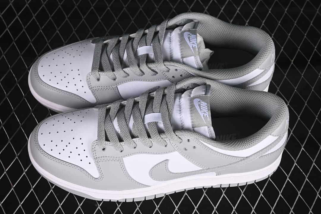 Pair of white and grey low-top sneakers viewed from above