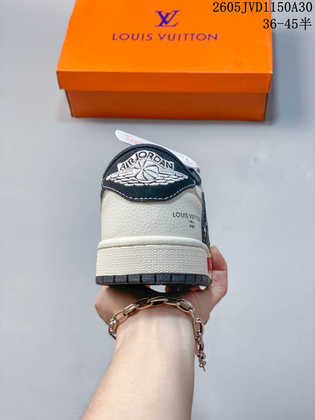 Rear view showing the heel panels, embroidered wing-style emblem, and contrasting outsole.