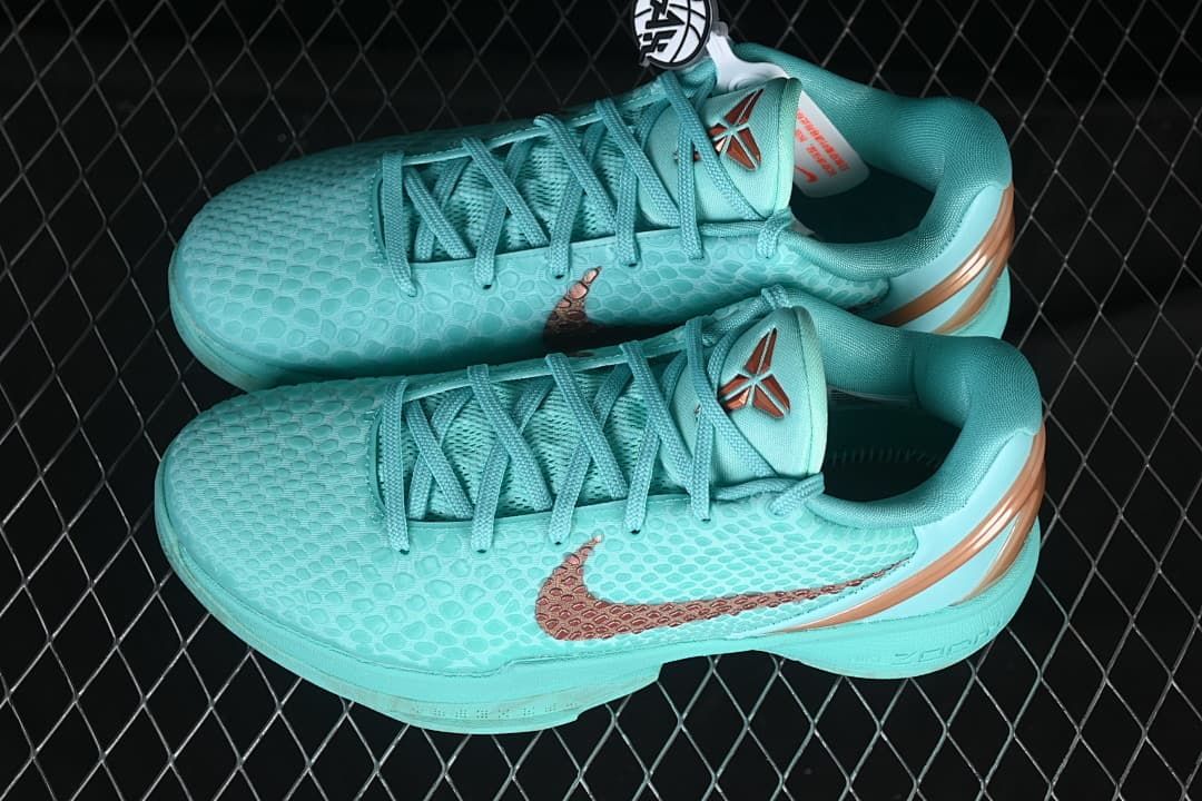 Pair of turquoise Kobe VI Protro shoes shown from above at an angle.