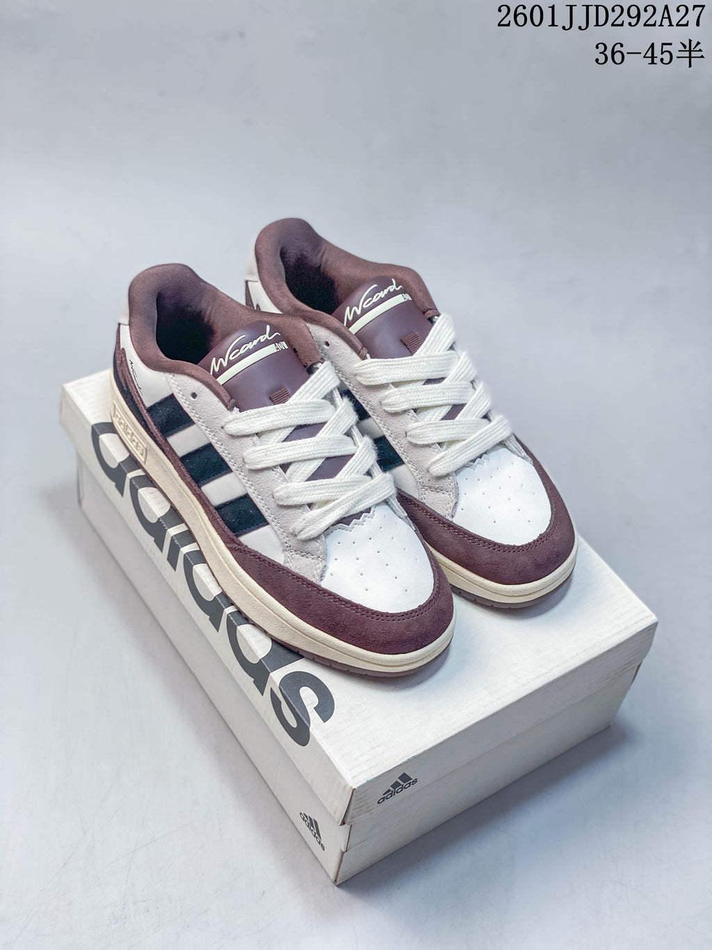 Pair of Adidas Wcard Adv low-top sneakers in white, navy and muted plum, shown on a shoe box.