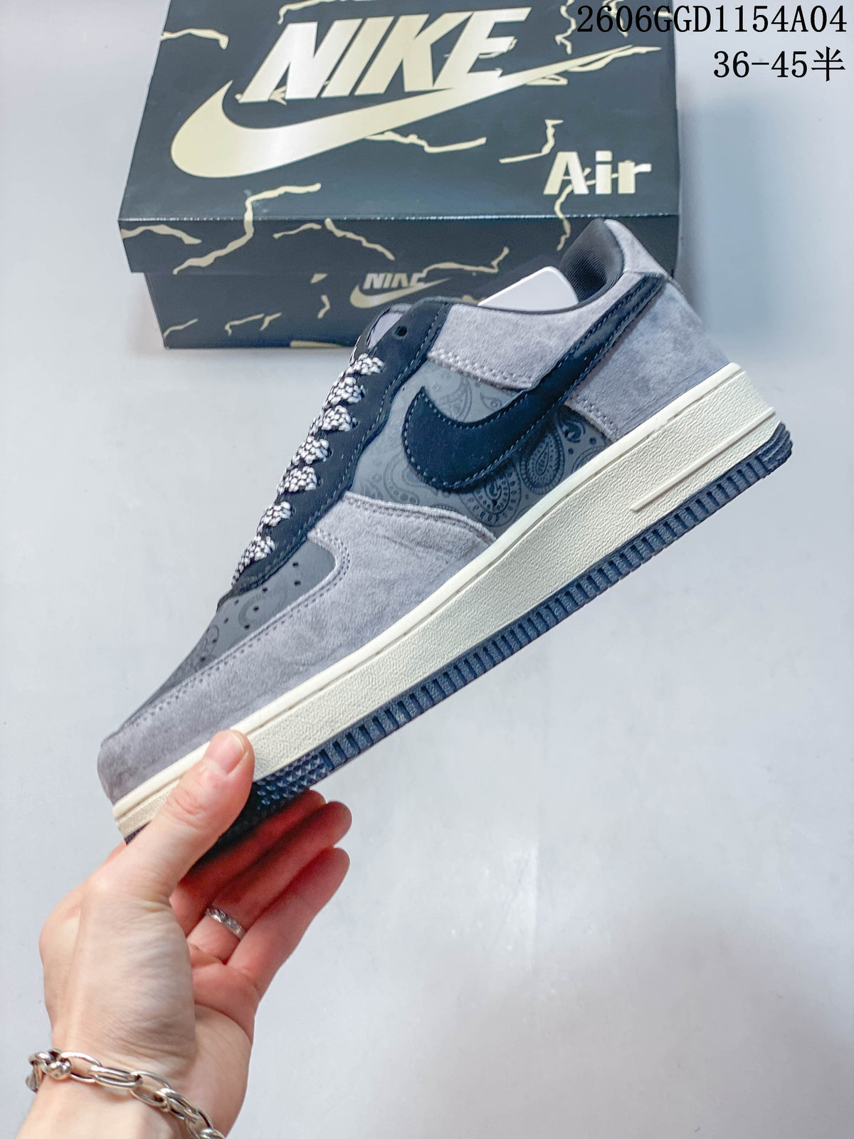 Side view of the sneaker with paisley panels, navy overlays, and grey accents