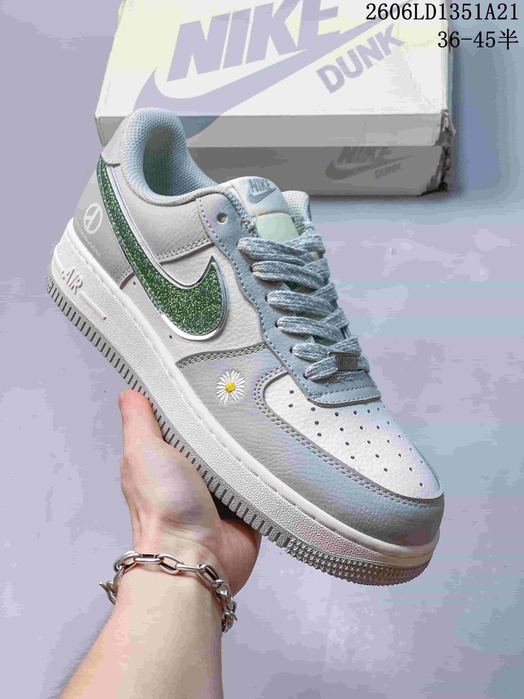 Angled side view highlighting the green Swoosh and small daisy detail