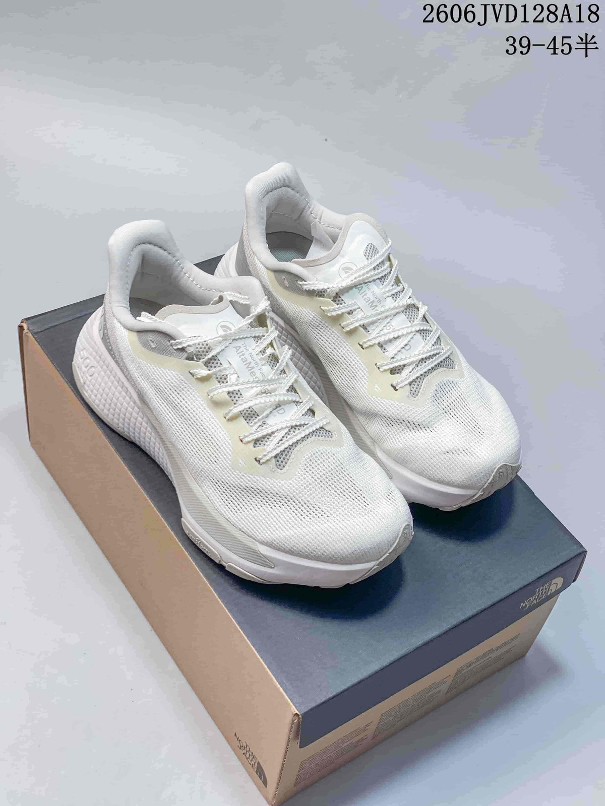 Pair of white Alta Mesa 500 running shoes with pale neutral details and white laces.