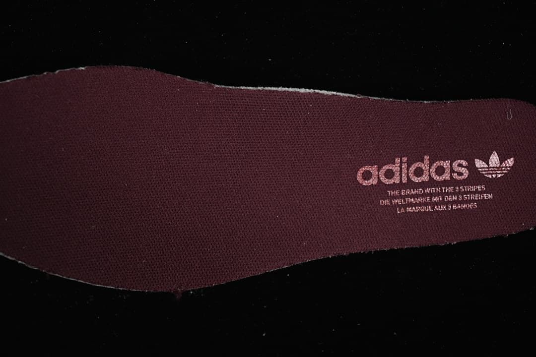 Burgundy insole with Adidas Trefoil branding.