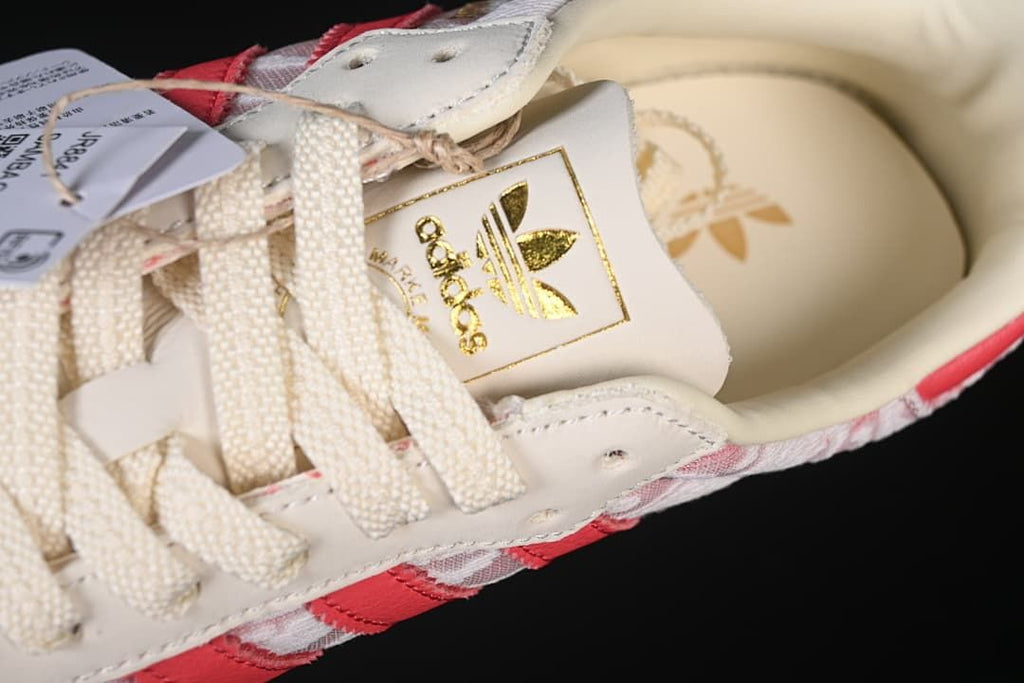 Top detail of the laces, tongue branding, and patterned panels