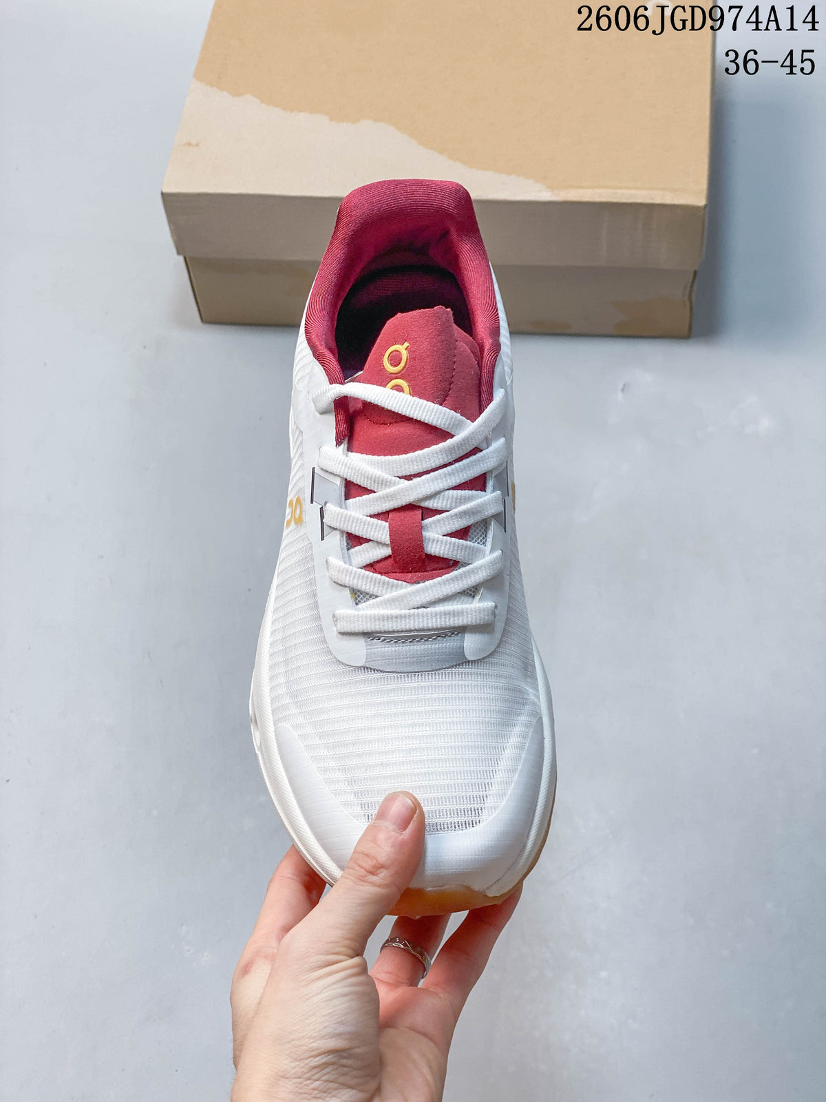Top view of a white trail running shoe with pink tongue and collar details and white laces.