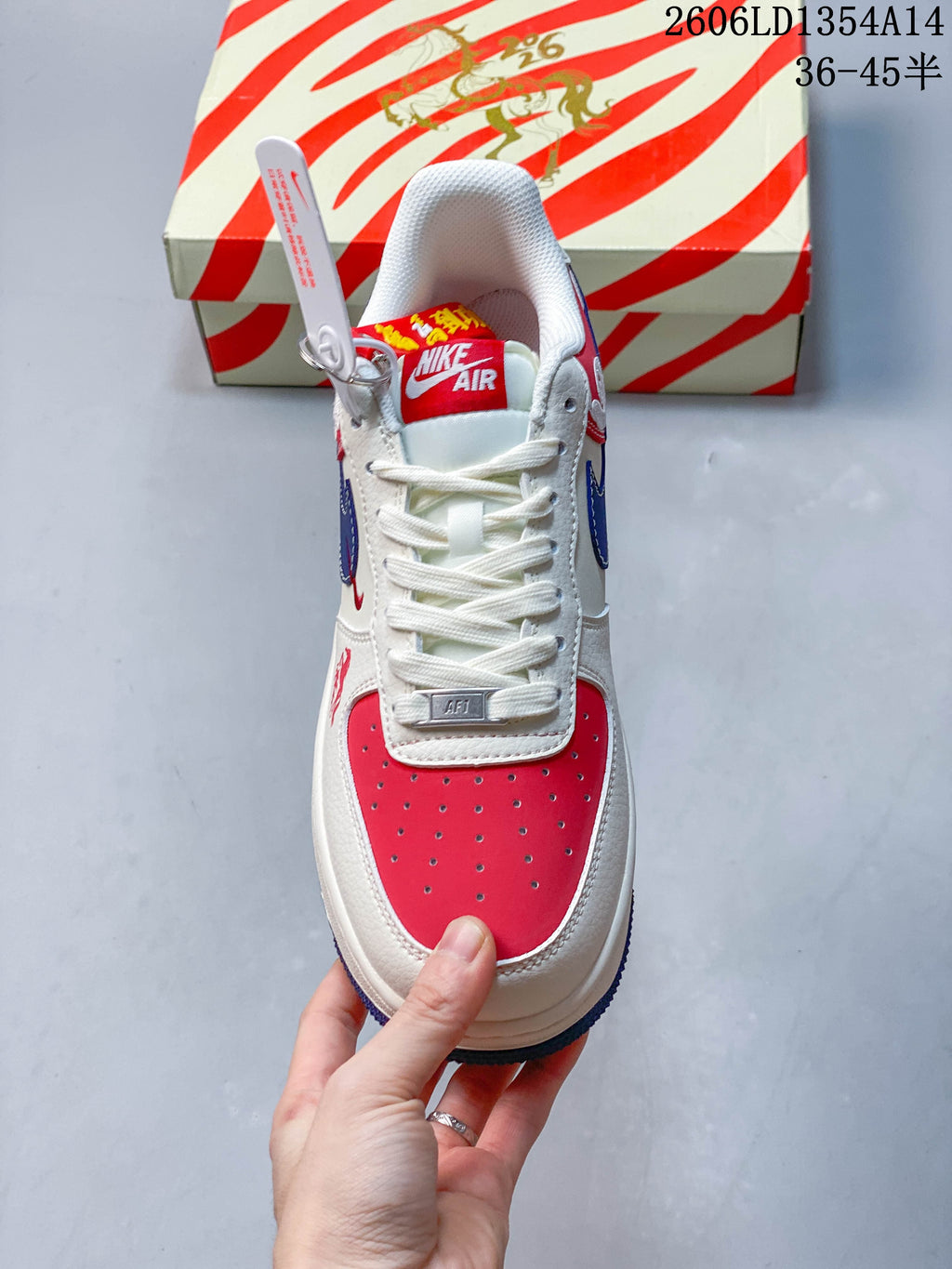 Top view showing white laces and a perforated red toe panel.