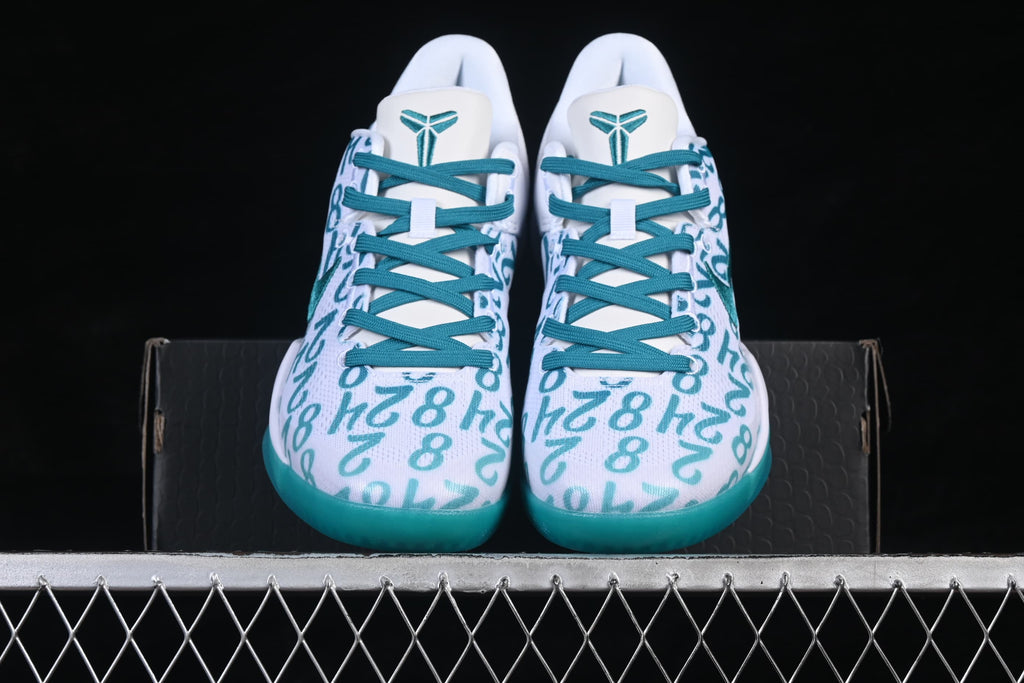 Pair of shoes viewed from the front, showing teal laces and patterned uppers