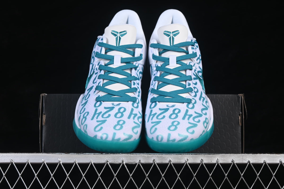 Pair of shoes viewed from the front, showing teal laces and patterned uppers