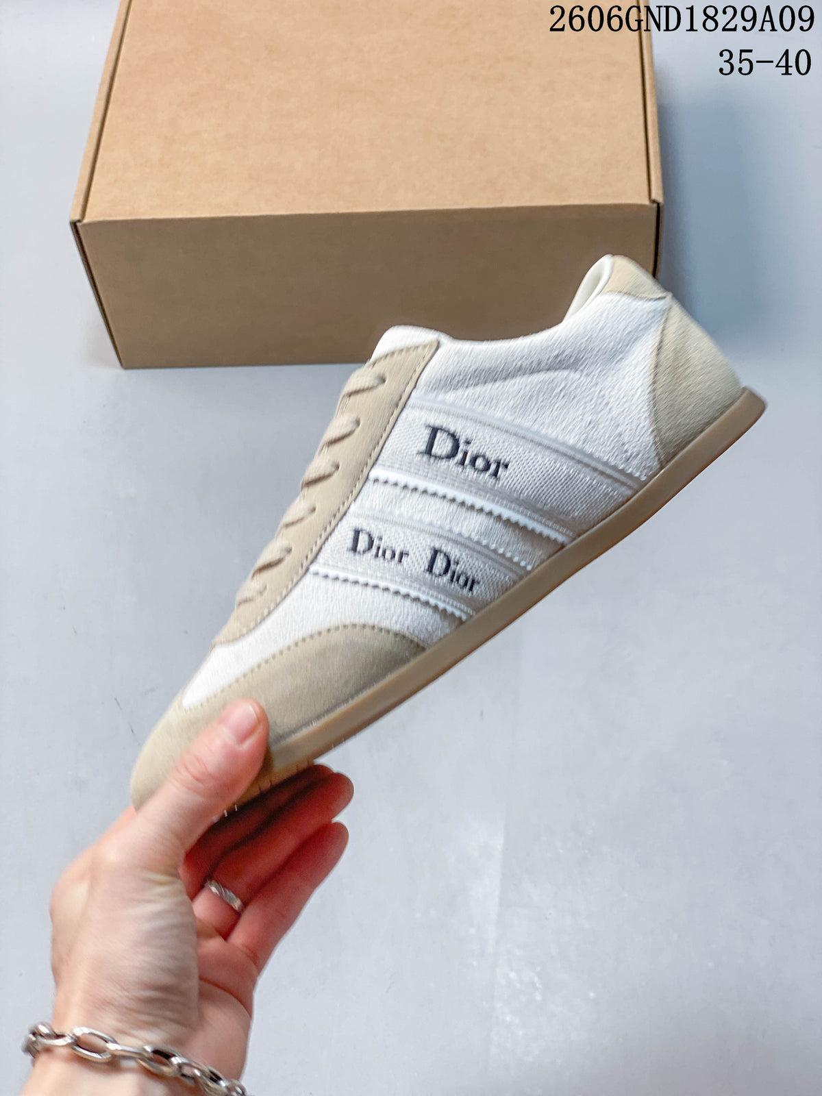 Side view showing cream panels, beige overlays, and Dior-lettered bands