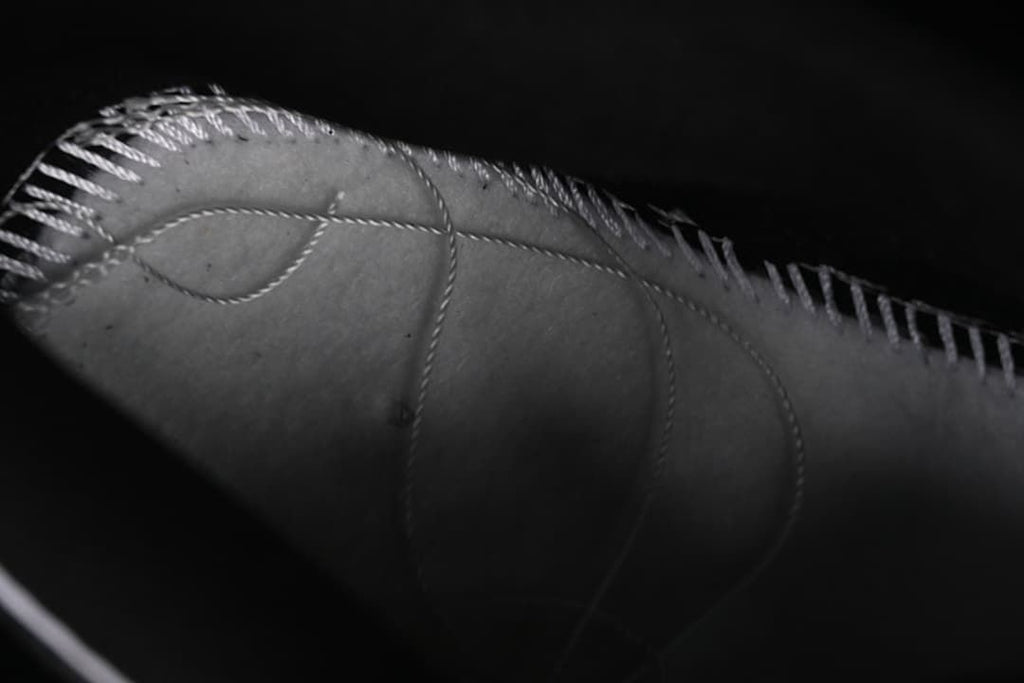 Close-up detail of stitching and panels on the sneaker upper