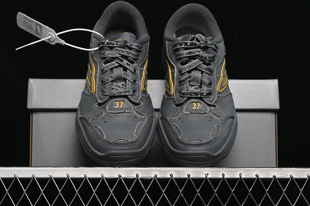 Front view of both sneakers displayed on the shoebox