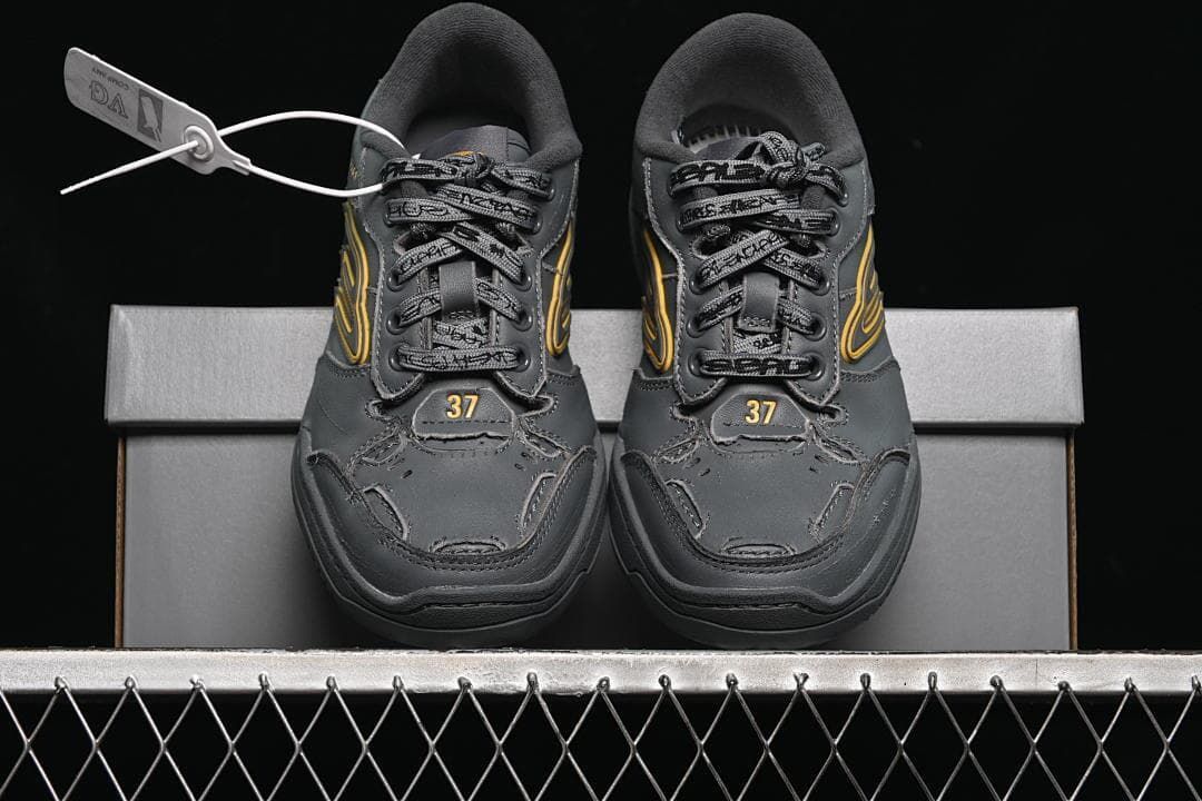 Front view of both sneakers displayed on the shoebox