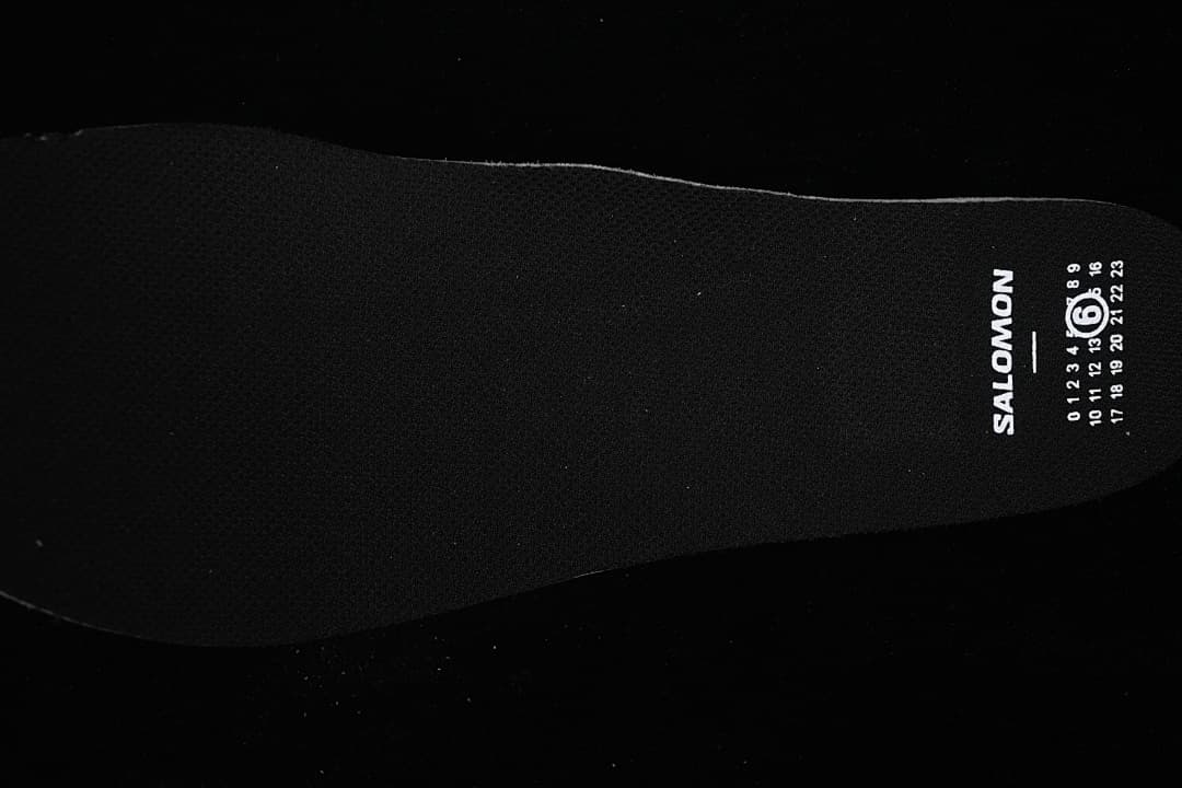 Black insole with Salomon branding and a numbered graphic