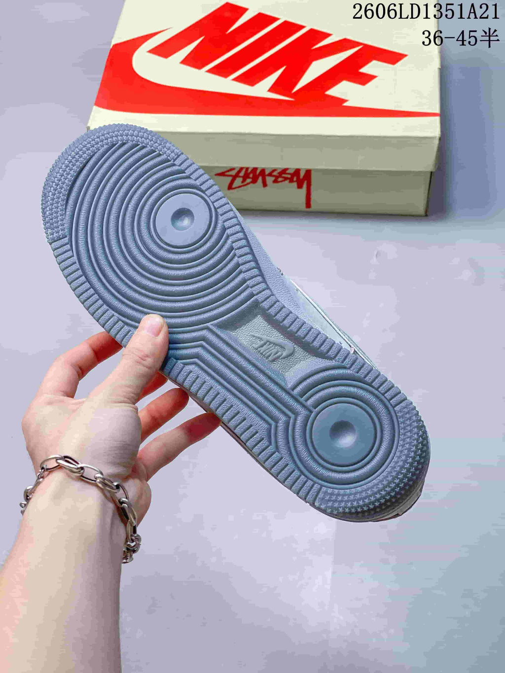 Close-up of the gray circular-pattern outsole and shoebox