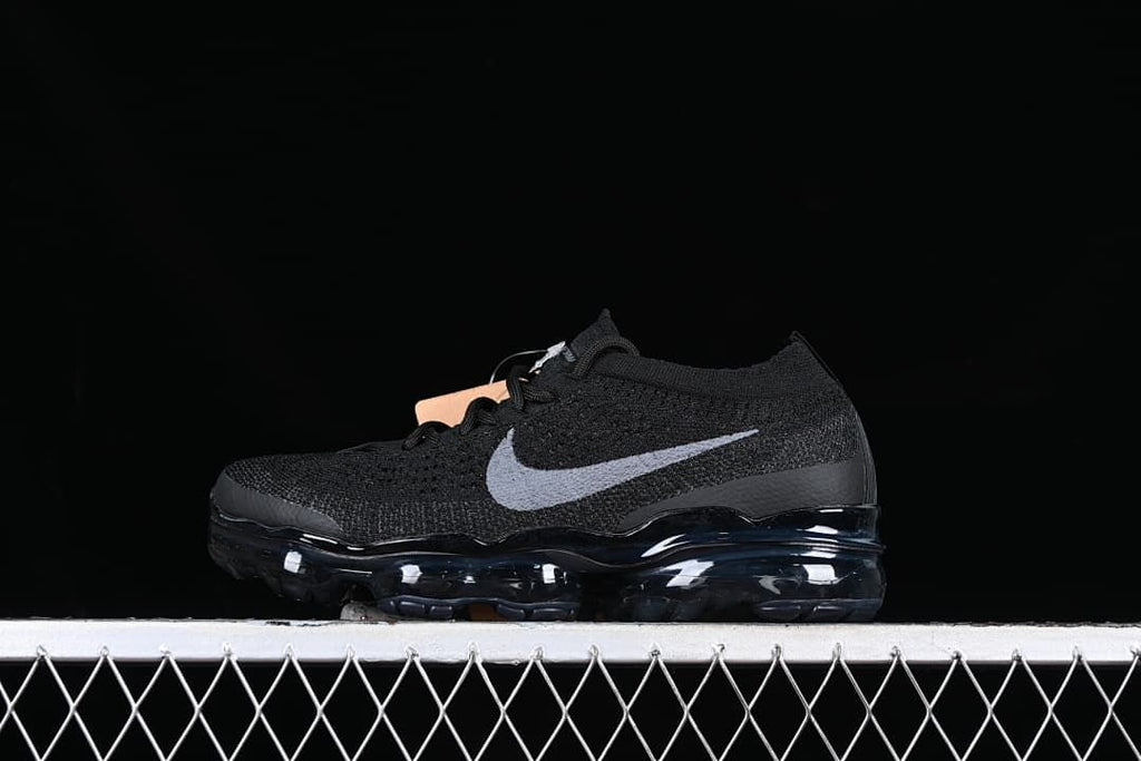 Black Nike VaporMax 2023 Flyknit sneaker with gray Swoosh, side view