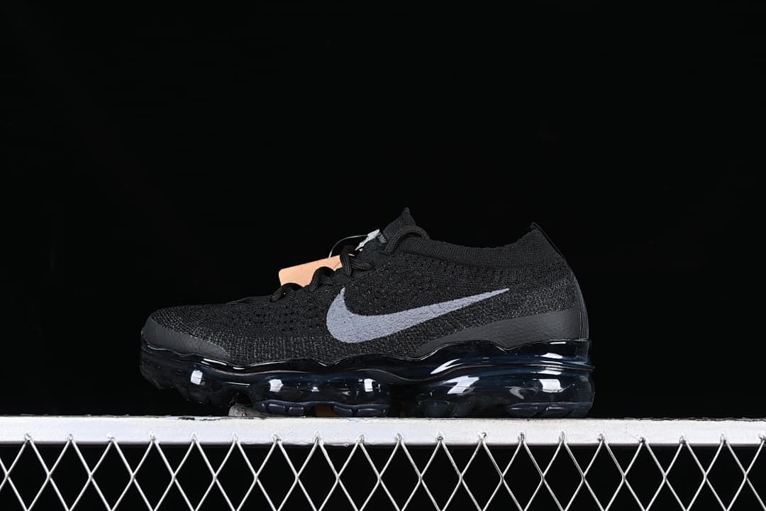 Black Nike VaporMax 2023 Flyknit sneaker with gray Swoosh, side view