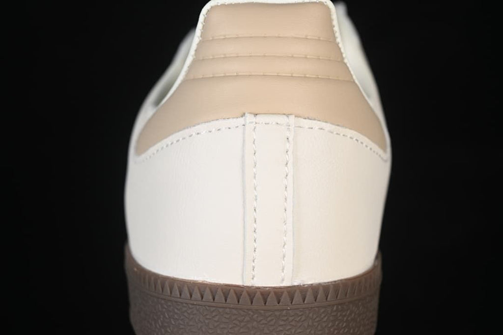 Rear view of the sneaker with a beige heel panel and dark brown sole