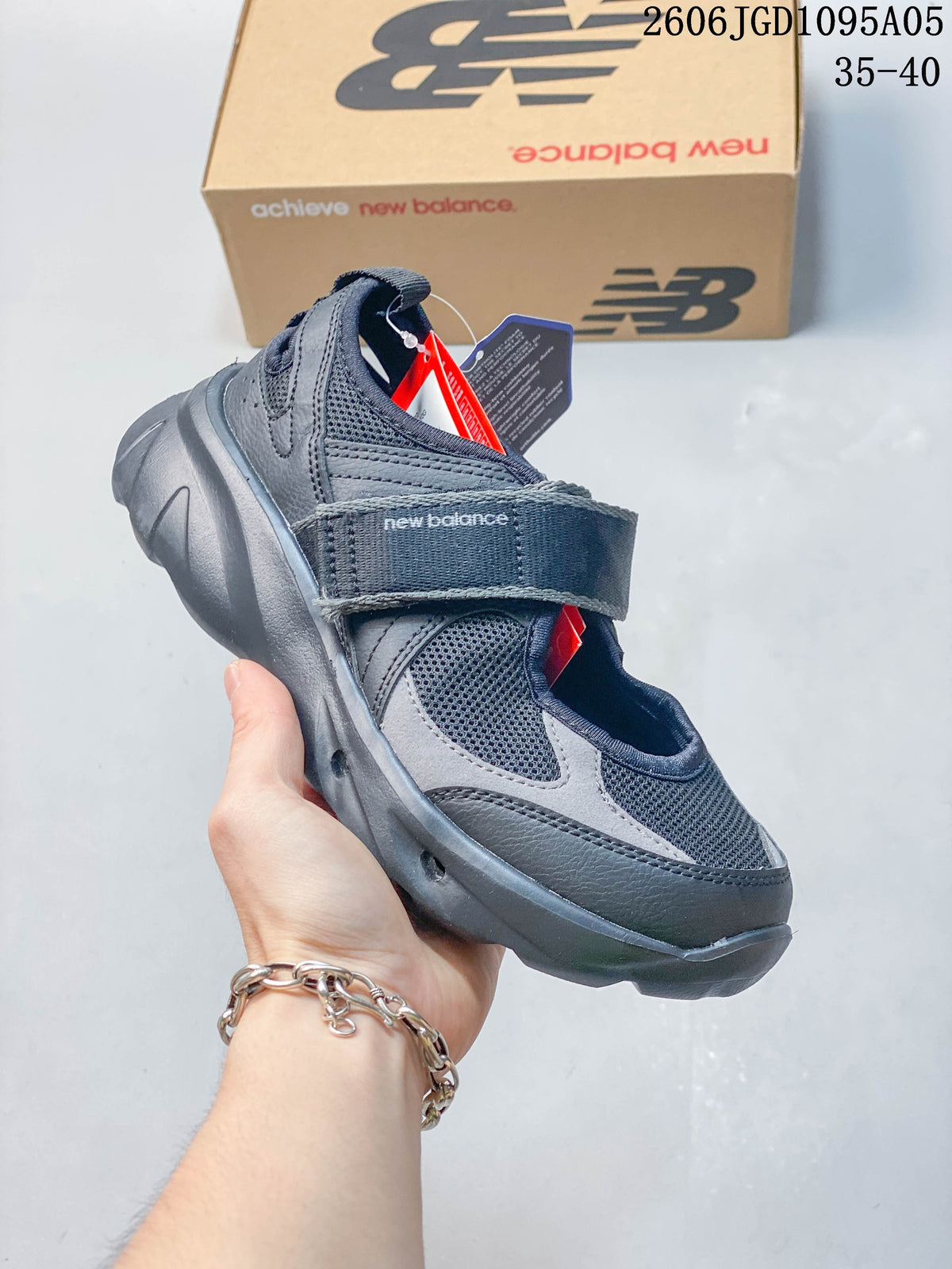 Angled side view of a dark gray New Balance Breeze Mary Jane sneaker