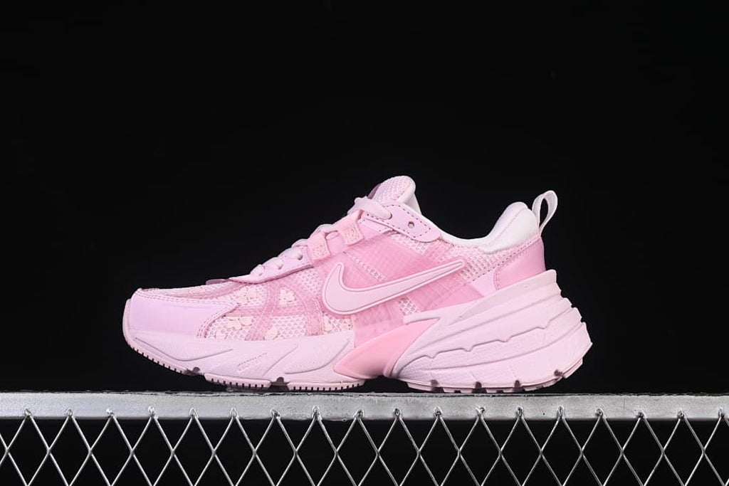 Side view of a pink Nike V2K Run sneaker with floral details