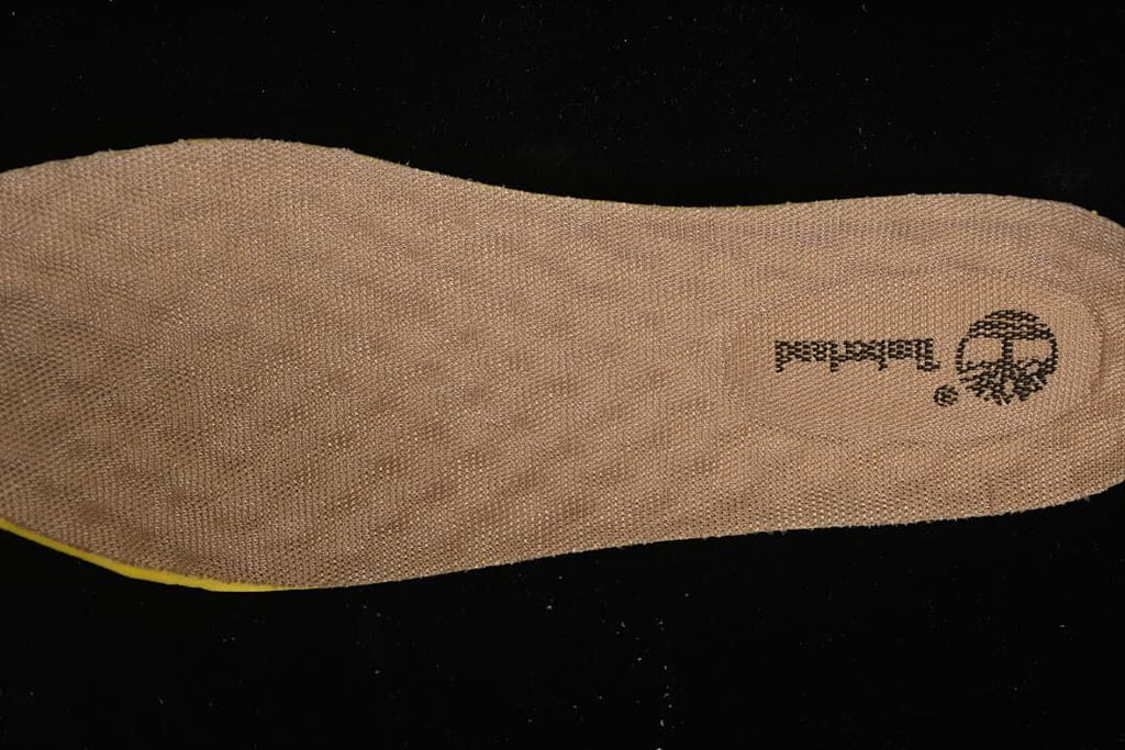 Textured tan shoe insert with Timberland branding