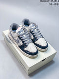 Pair of white, navy, and gray Nike Dunk Low x Undefeated sneakers on a box