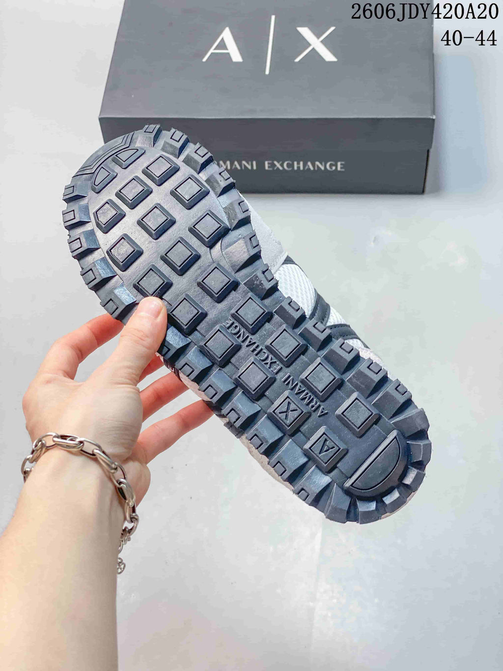 Close-up of the dark lugged outsole on an Armani Exchange sneaker