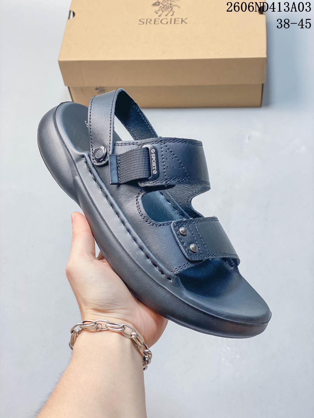 Side view of a navy sandal showing its adjustable upper strap and heel strap; the image states sizes 38–45.