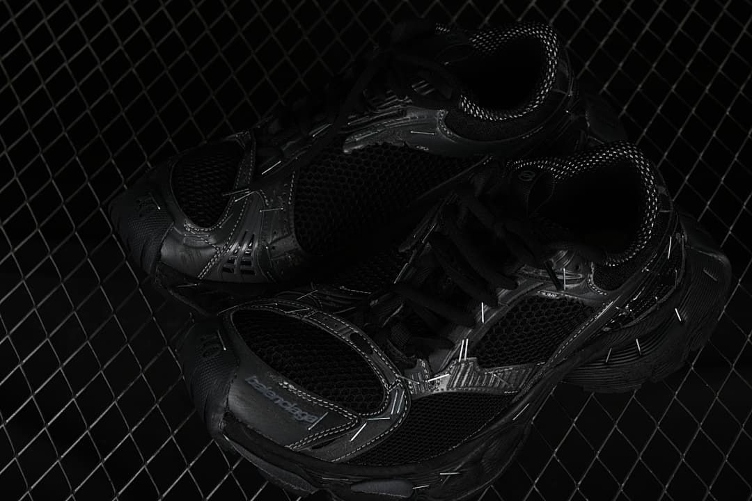 Pair of black sneakers shown from above at an angle.