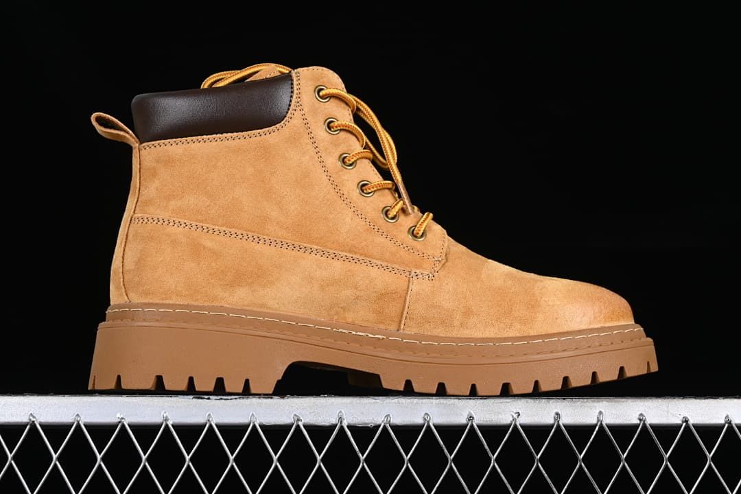 Side profile of a yellow-brown mid-top lace-up boot