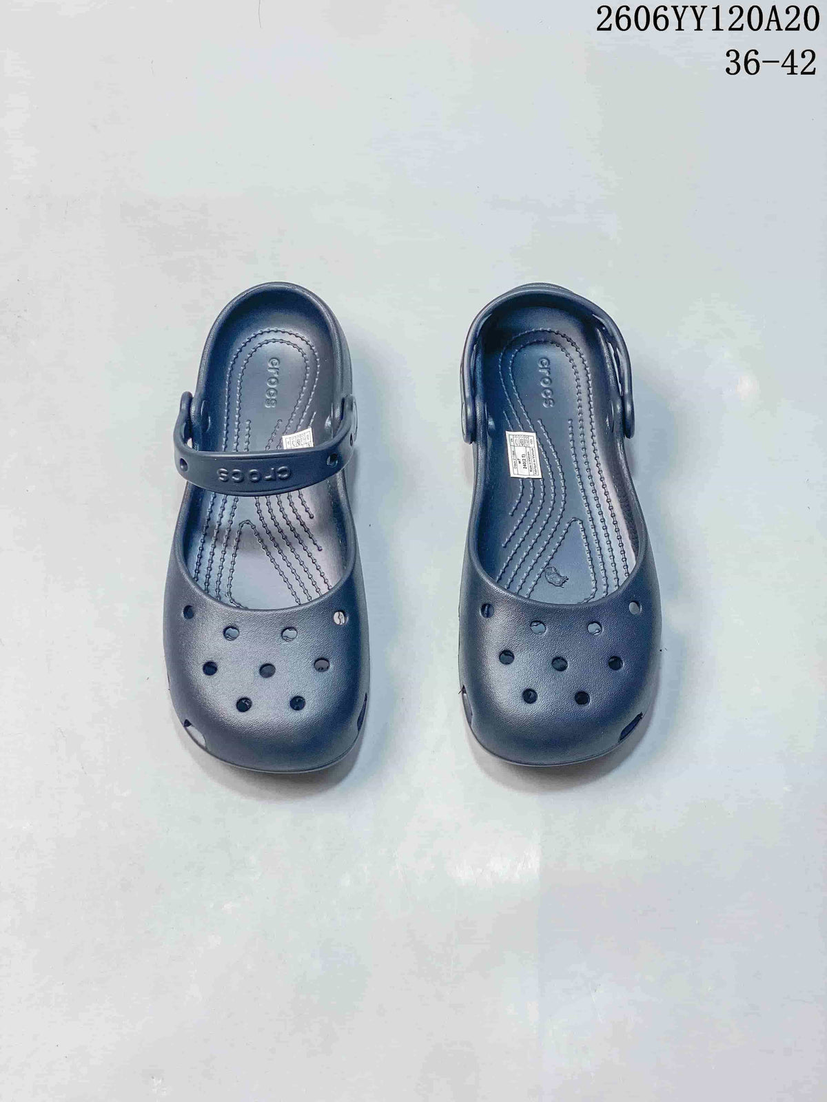Pair of navy Crocs-branded clog-style shoes shown from above with ventilation openings and heel straps; image text shows style code 2606YY120A20 and sizes 36–42.
