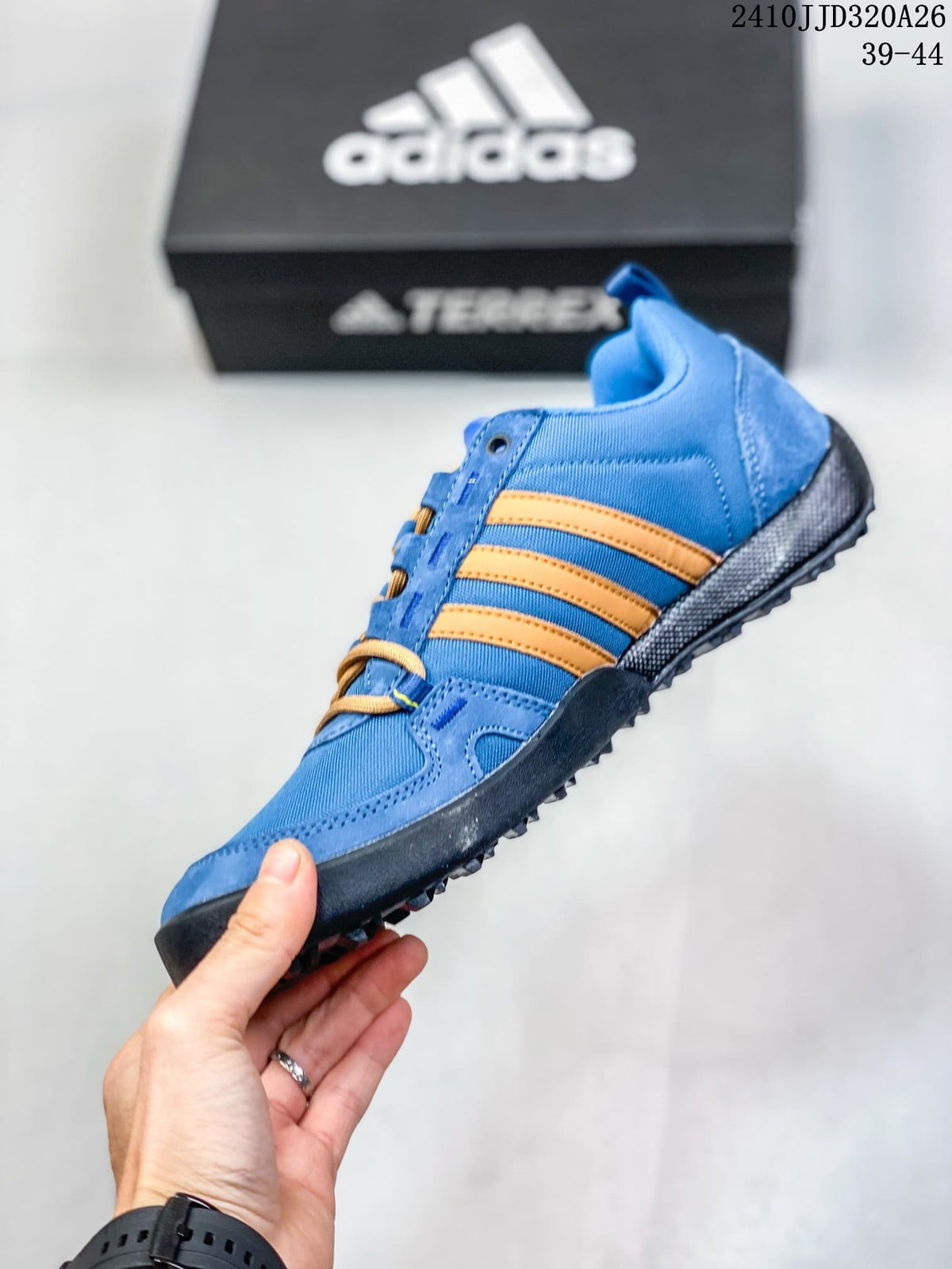 Side view of the blue adidas Daroga Plus shoe with orange stripes and a dark outsole.