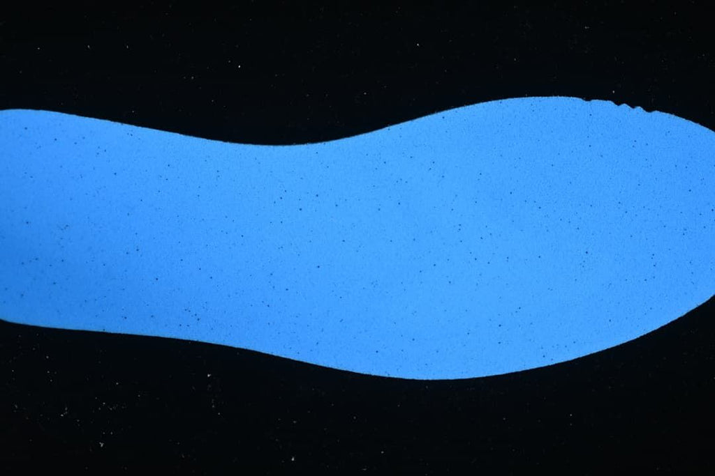 Blue outsole shown against a dark background