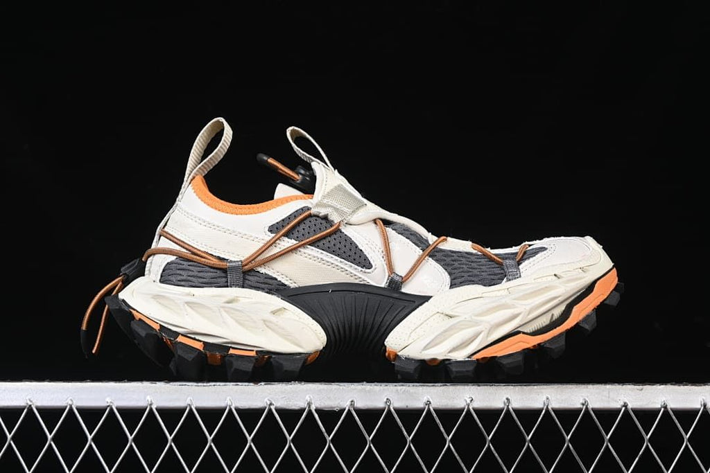 Side profile of the sneaker with its layered upper and lugged sole