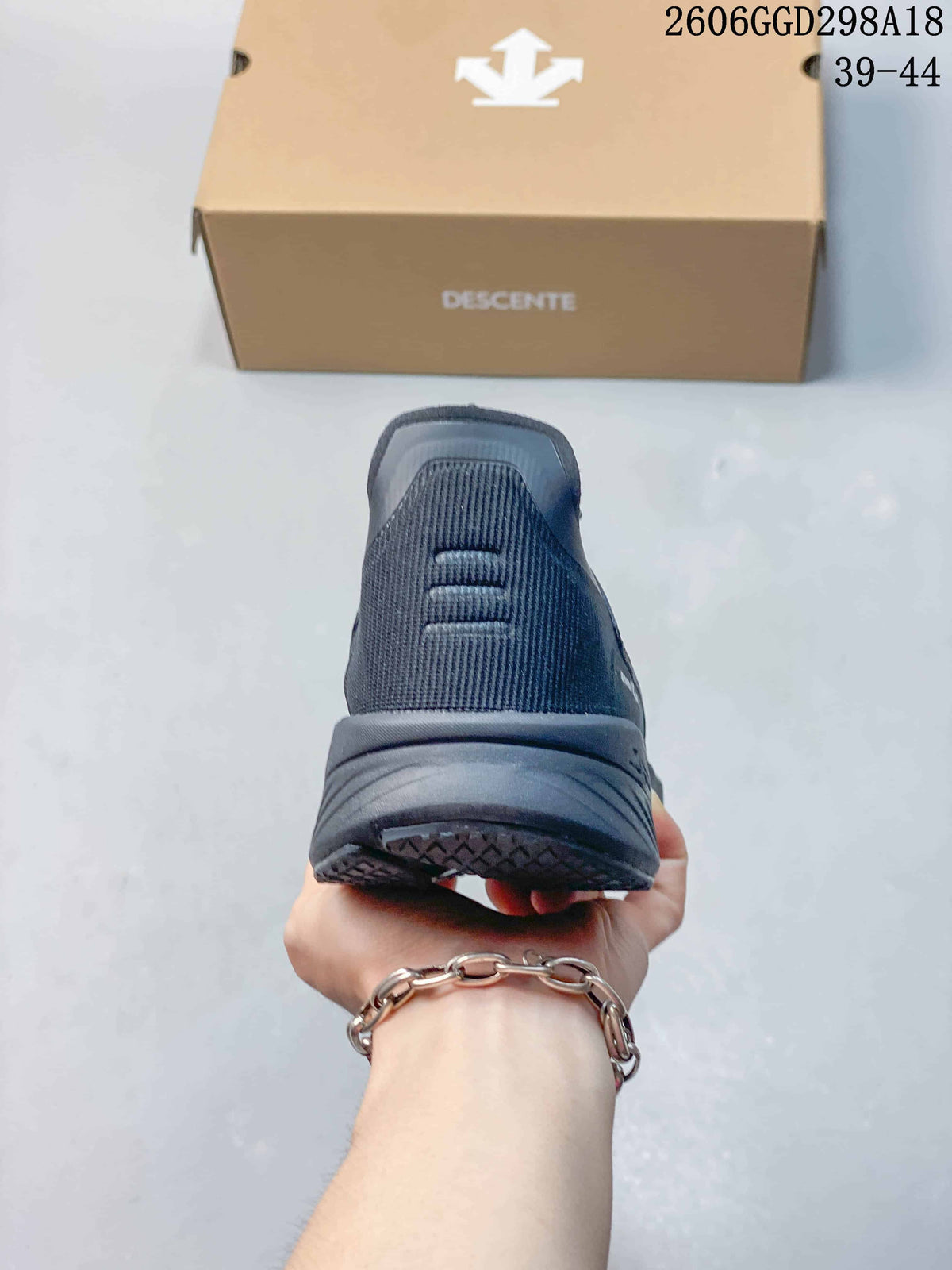 Rear view of the dark gray sneaker showing the heel and outsole