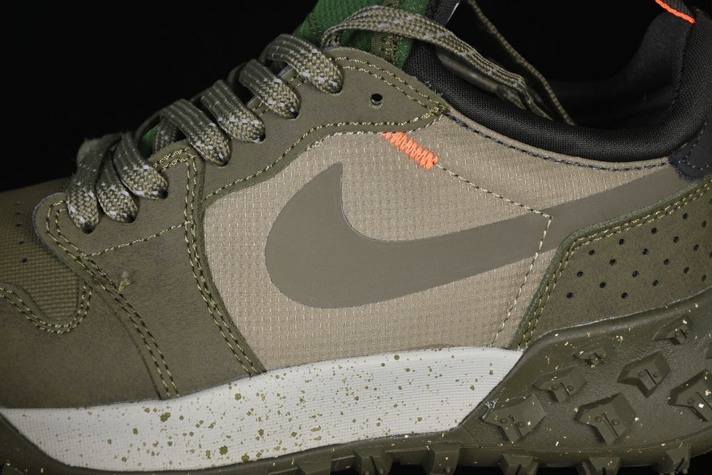 Close-up of the side panel, gray Swoosh, stitching, and speckled midsole.