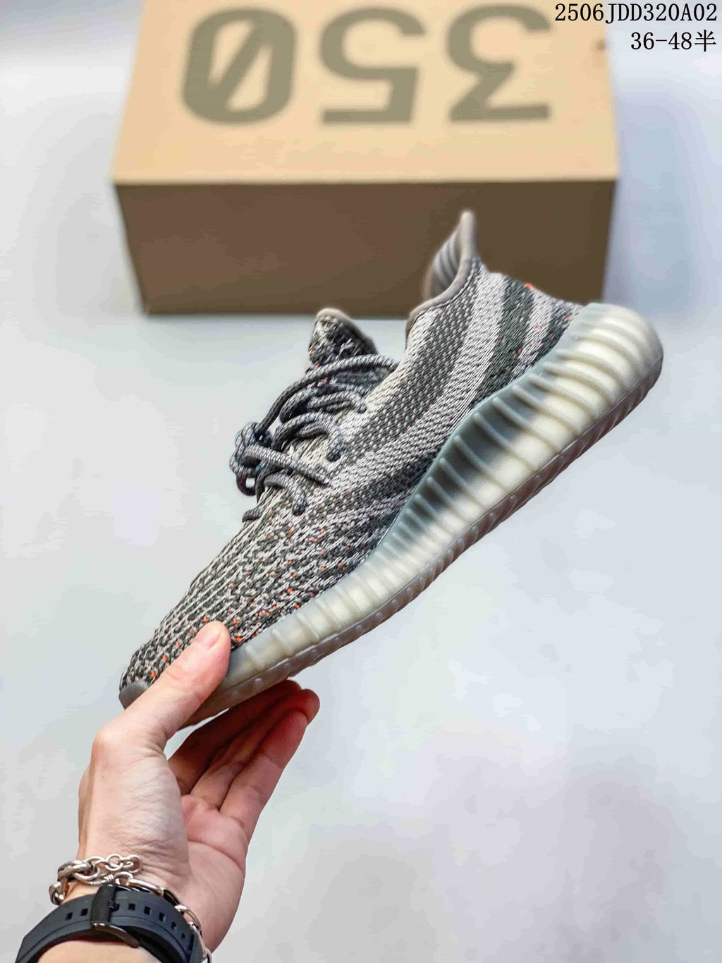 Side profile of a gray knit-look sneaker with orange accents and a translucent ribbed sole; image overlay states 36–48.5.