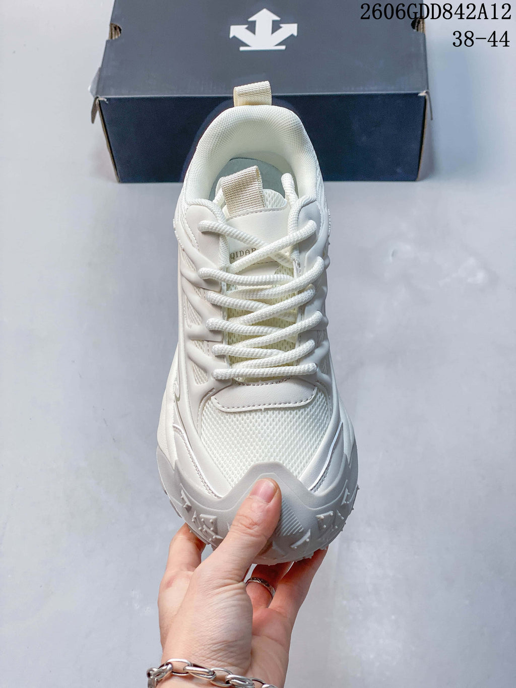 Front view of the white lace-up DESCENTE sneaker; the image displays size range 38–44.