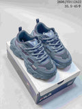 Gray-blue FILA sneakers with a chunky sculpted sole, displayed on a shoebox.