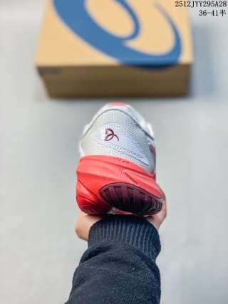 Rear view of the sneaker showing the white heel, red midsole and dark outsole section.